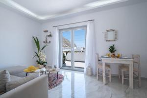 a white living room with a table and a couch at Perissa Secret in Perissa +24 photos