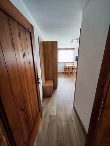 a hallway with a door and a room with a table at Malostranská restaurace in Lišov