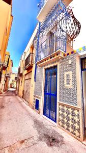 un edificio con puertas azules y balcón. en Sant'Agostino Suites & Rooms, en Mazara del Vallo