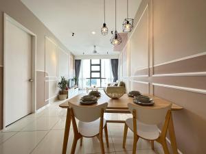 a dining room with a wooden table and chairs at Zen Stay in Kuala Lumpur