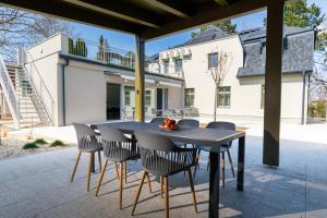 a black table and chairs on a patio at PARK Apartmanok in Balatonszárszó