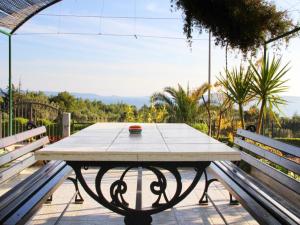 a table with a bowl on it sitting between two benches at Apartment M in Seget Vranjica +9 photos