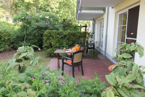 a patio with a table and chairs on a house at Altes Wasserwerk App 03 in Wustrow