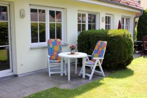 a table and two chairs sitting on a patio at Wohnpark Schmiedestraße App 16 in Wustrow