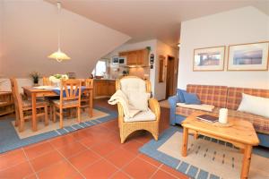 a living room with a couch and a table at Haus Clarissa, App 02 in Wustrow