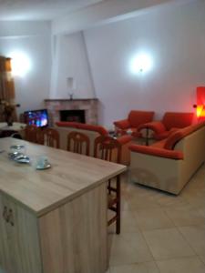 a living room with red furniture and a fireplace at TAFA A. in Fier