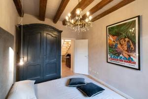 a bedroom with a large bed and a chandelier at CRoix 1541 - CIR 0198 in Aosta