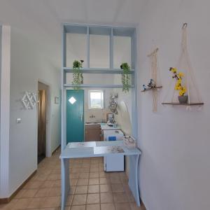 een keuken met een blauwe tafel en een wastafel bij Arocaria - Faliraki peaceful apartments in Faliraki