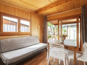 a porch with a bench and a table and chairs at Camping Fano in Fano