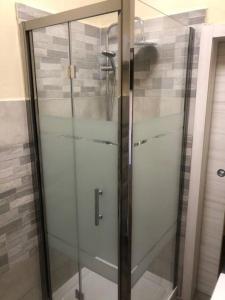 a shower with a glass door in a bathroom at Casa Medicea sul canale in Livorno