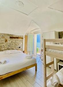 a bedroom with a large bed and a balcony at Casa Caterina in Lezzeno