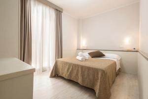 a hotel room with a bed and a window at Echotel in Porto Recanati