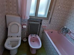 a bathroom with a toilet and a sink and a tub at Locazione Turistica in Tessera