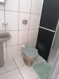 a bathroom with a toilet and a sink at quarto para Rapaz, centro, Sinop MT in Sinop +19 photos