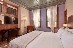 Postel nebo postele na pokoji v ubytování Domus Renier Boutique Hotel