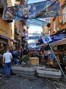 a crowd of people walking around a market in a city at Eleonora's Home in Naples