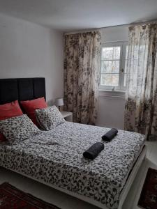 a bedroom with a bed with two pillows on it at Kolbergarden in Olsztyn