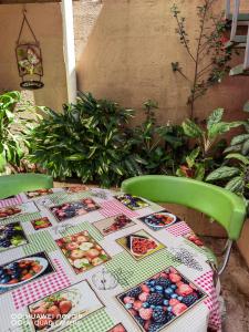 a table with a table cloth with pictures of food on it at Casa Mariana in Alajuela
