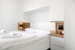 1 dormitorio con 2 camas con sábanas blancas en Apartments Terra Sun with Private Pool or Jacuzzi, en Njivice