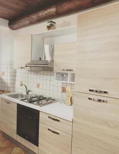 a kitchen with a sink and a stove top oven at Ca Angela in Mergozzo