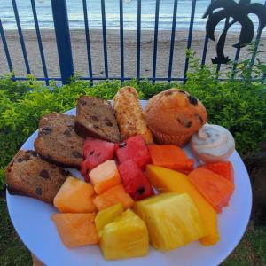 a plate of fruit and vegetables on the beach at Hotel Villa Amarilla in Tamarindo