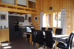 a kitchen and dining room with a table and chairs at Chalet Mille Étoiles in Zinal