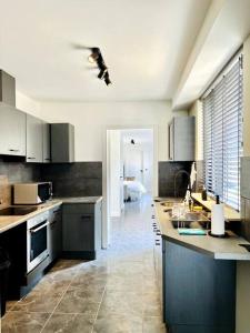 a kitchen with a sink and a counter top at Van Gogh Duplex Eindhoven-Nuenen in Nuenen