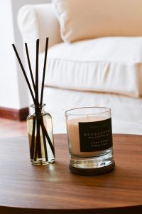 a glass candle and a vase on a table at Hotel Celta in Vigo