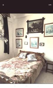 a bedroom with a bed with pictures on the wall at Repose toi c comme chez soi in Oujda