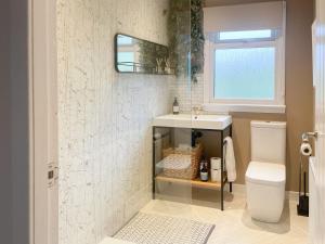 a bathroom with a sink and a toilet at Mossdale Cottage in Dalmellington