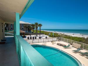 a view from the balcony of a resort with a swimming pool and the beach at Chateau 6W Alluring Beachfront Condo in Clearwater Beach