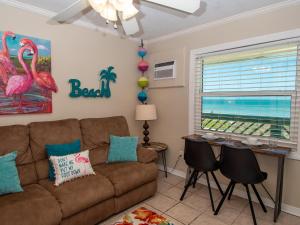 a living room with a couch and a table at Chateau 6W Alluring Beachfront Condo in Clearwater Beach