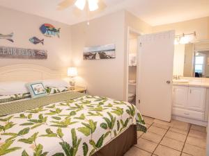 a bedroom with a bed and a bathroom at Chateau 6W Alluring Beachfront Condo in Clearwater Beach