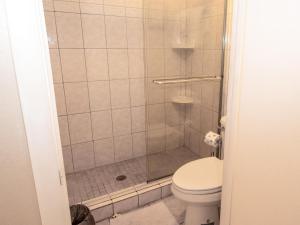 a bathroom with a shower with a toilet at Chateau 6W Alluring Beachfront Condo in Clearwater Beach +24 photos
