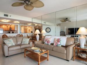a living room with a couch and a table at Crescent Beach Club 3B Beachfront Views of the Gulf in Clearwater Beach