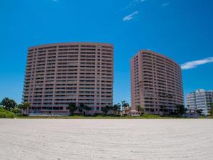 two tall buildings in front of a sandy beach at Crescent Beach Club 3B Beachfront Views of the Gulf in Clearwater Beach