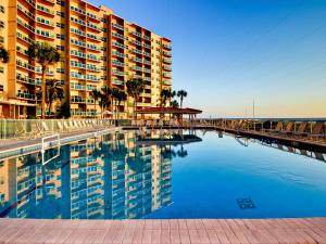 a swimming pool in front of a large building at Regatta Beach Club 403N 90 day min in Clearwater Beach