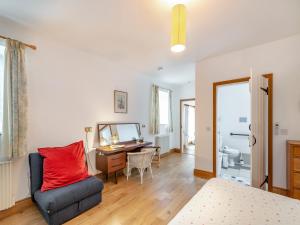 a bedroom with a bed and a desk and a chair at The Byre in Eggleston