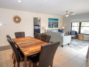 - une salle à manger et un salon avec une table et des chaises en bois dans l'établissement Villas of Clearwater Beach 4B Steps from the Beach, à Clearwater Beach