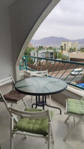 a table and chairs on a balcony with a view at Yona balev in Eilat