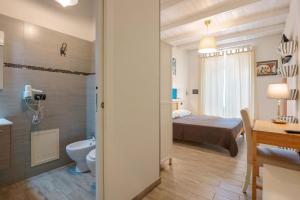 a bedroom with a bed and a bathroom with a toilet at Il Cagliarese B&B in Cagliari