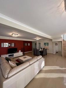 a large living room with a couch and a table at Seascape Beach House in Capel