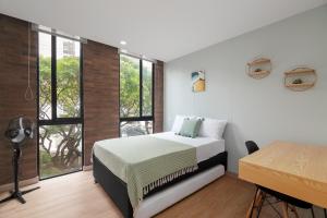 a bedroom with a bed and a large window at Súper apartamento en Laureles in Medellín