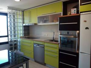 a kitchen with lime green cabinets and a sink at DUPLEX 3 DORMITORIOS PLAYA FOZ in Foz