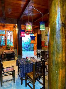 a dining room with a table and chairs and a chandelier at Surelee Homestay in Sapa