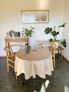 a table with two chairs and a table with a tablecloth at Casa La Quinta - Tiny House in San Carlos de Bariloche