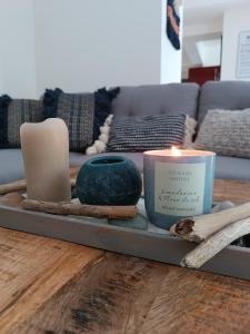 a tray with candles on a table with a couch at Havre de paix Les pélicans in Vichy