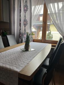 a table with a potted plant on it next to a window at Chowancówka in Biały Dunajec