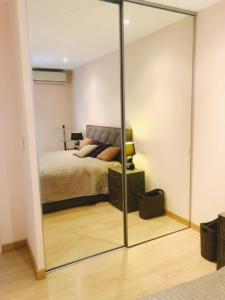 a bedroom with a bed and a large mirror at Luxurious appartment near the airport Nice in Nice