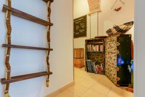 a room with two wooden shelves on the wall at Il Cagliarese B&B in Cagliari